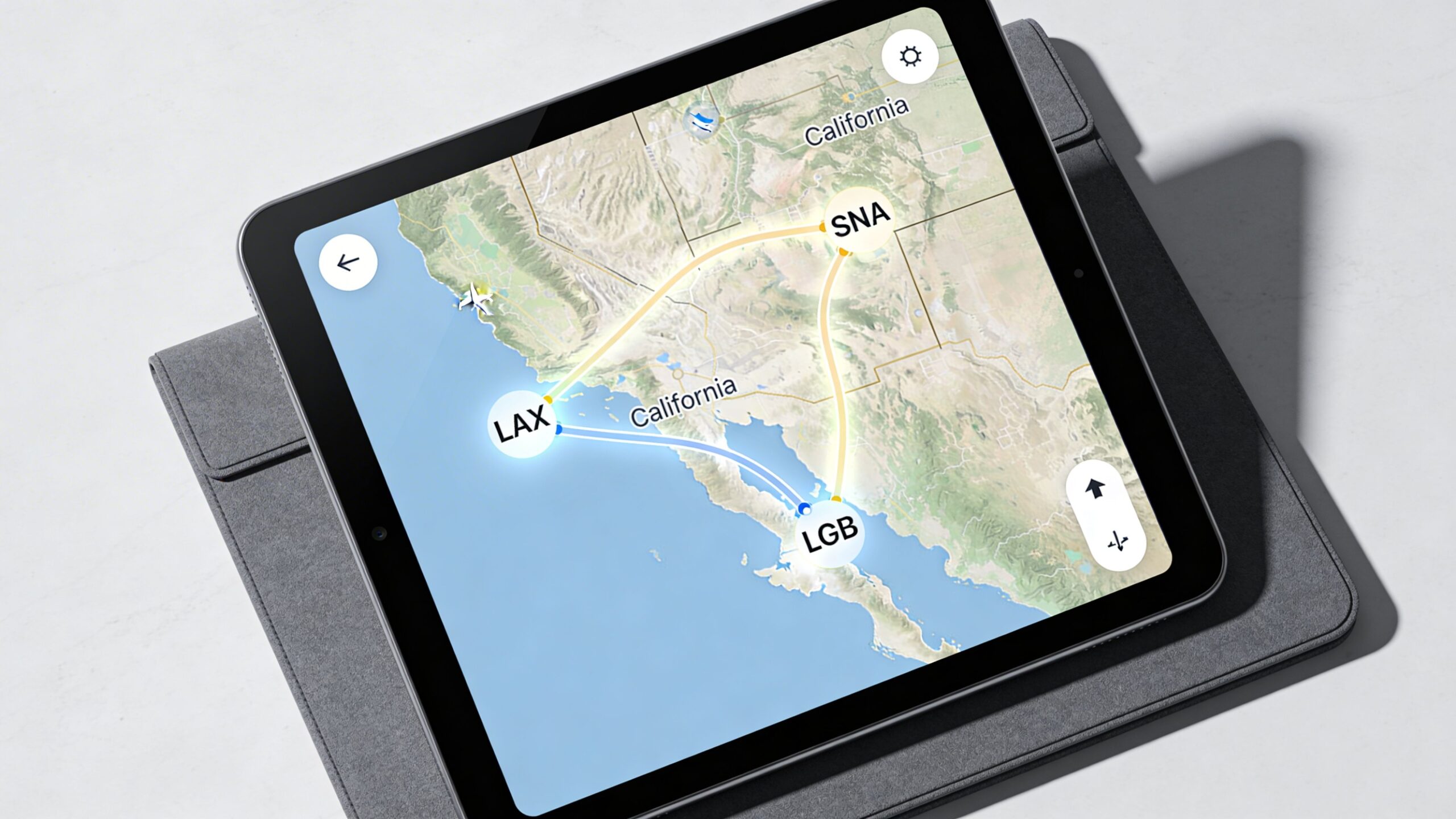 A tablet device displaying a digital map with flight paths connecting LAX, SNA, and LGB airports in California.
